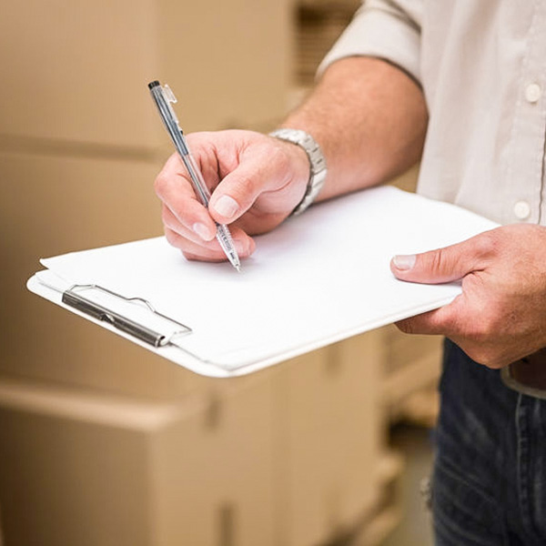Man using clipboard to check mailing details