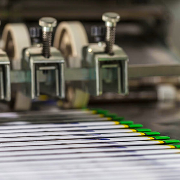 Booklets on folding machine in printing house.